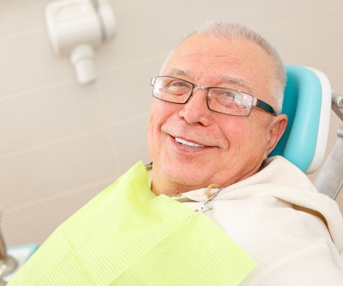 Smiling senior man sitting in dental chair
