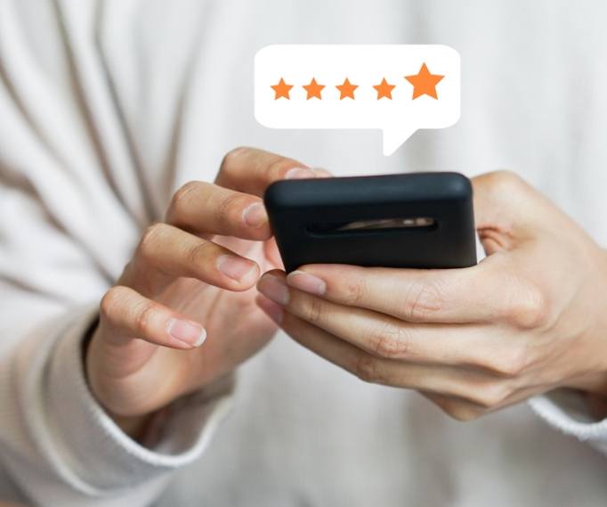 Person leaving a five star review on their phone