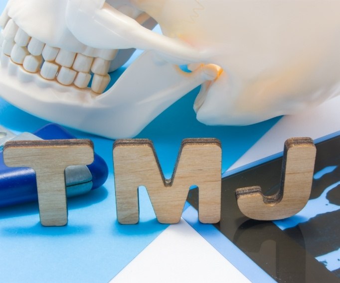 Model of skull next to wooden letters T M J